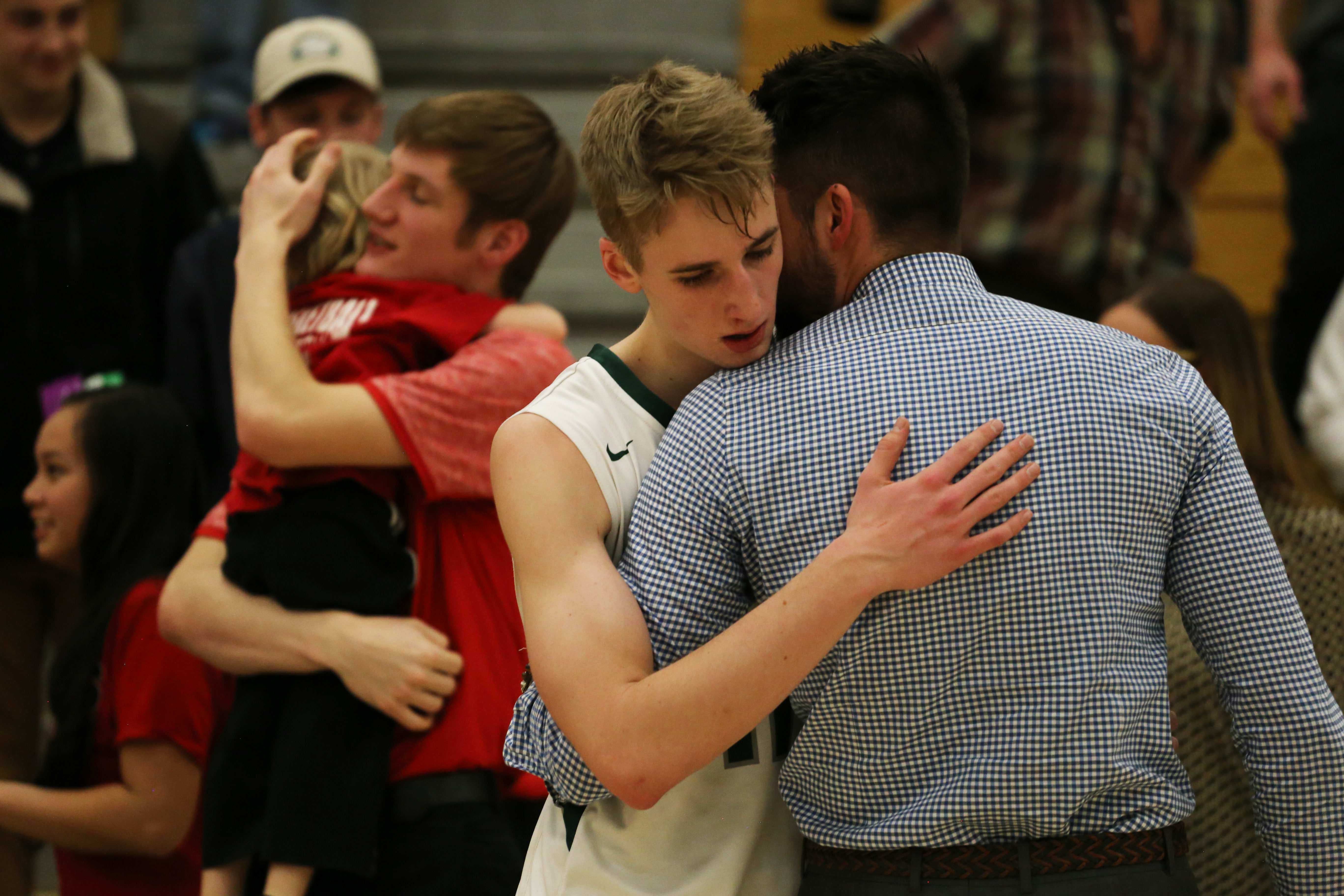 Senior Kellen Ireland hears words of encouragement and consolation from Coach Eric Valerio following the first round playoff loss to Glenwood Springs on Wednesday, February 22.