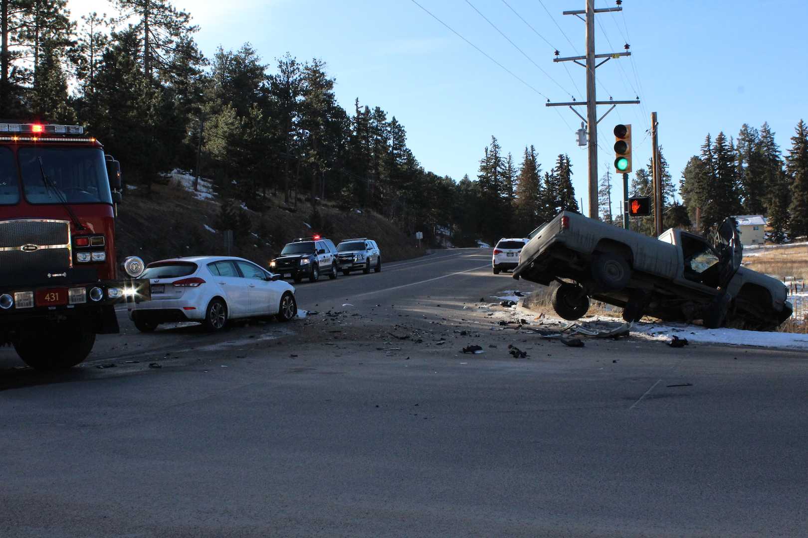 Debris decorates the intersection at Highway 73 and the Conifer High School driveway on the morning of Thursday, March 2, after an accident involving a student and an unidentified male driving a truck on Hwy 73.