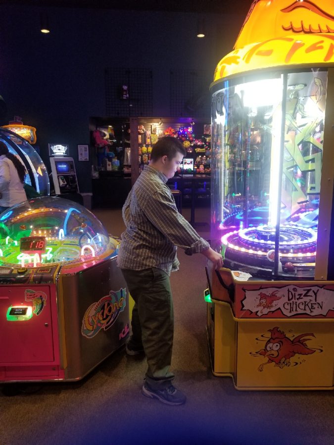 Pete Burns enjoys an arcade game at The Wild Game during the Fall field trip.