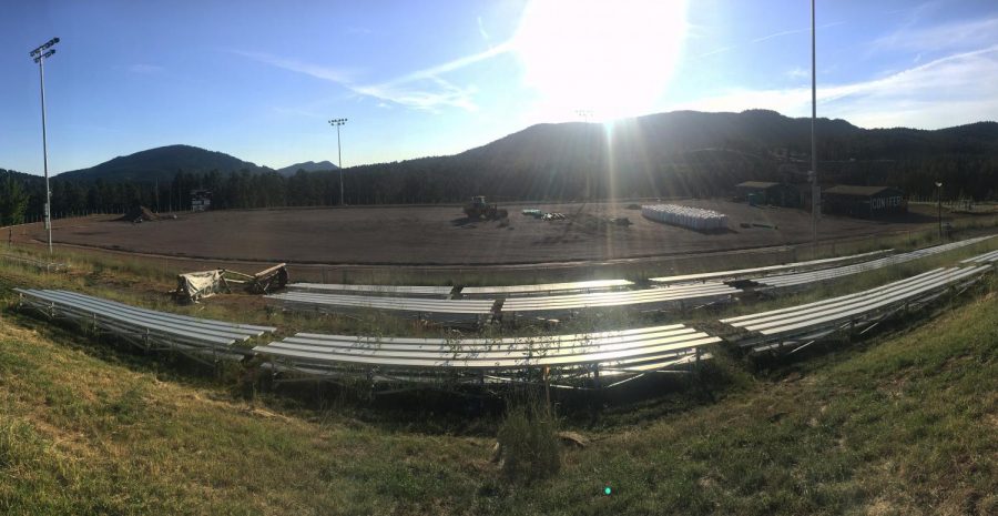 Early morning sunlight illuminates the construction project on the football field.  