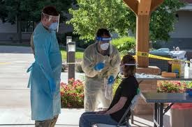 A nurse in Colorado being instructed on COVID-19 testing procedures