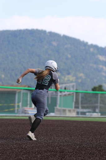 Senior, Ashley Fritz, makes a run for second base. Fritz has been playing softball for about ten years. “I just try to think of anything that can help my team score.” Fritz said.