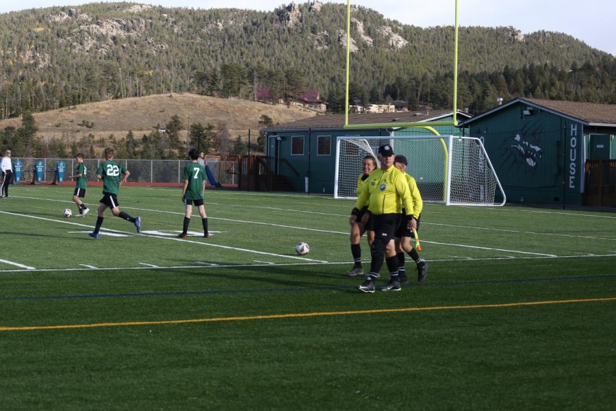 While so many games are seeing a shortage of referees, this soccer game will have all three required referees. The referees march onto the field proudly, ready to officiate the Varsity match between the Evergreen Cougars and the Conifer Lobos.