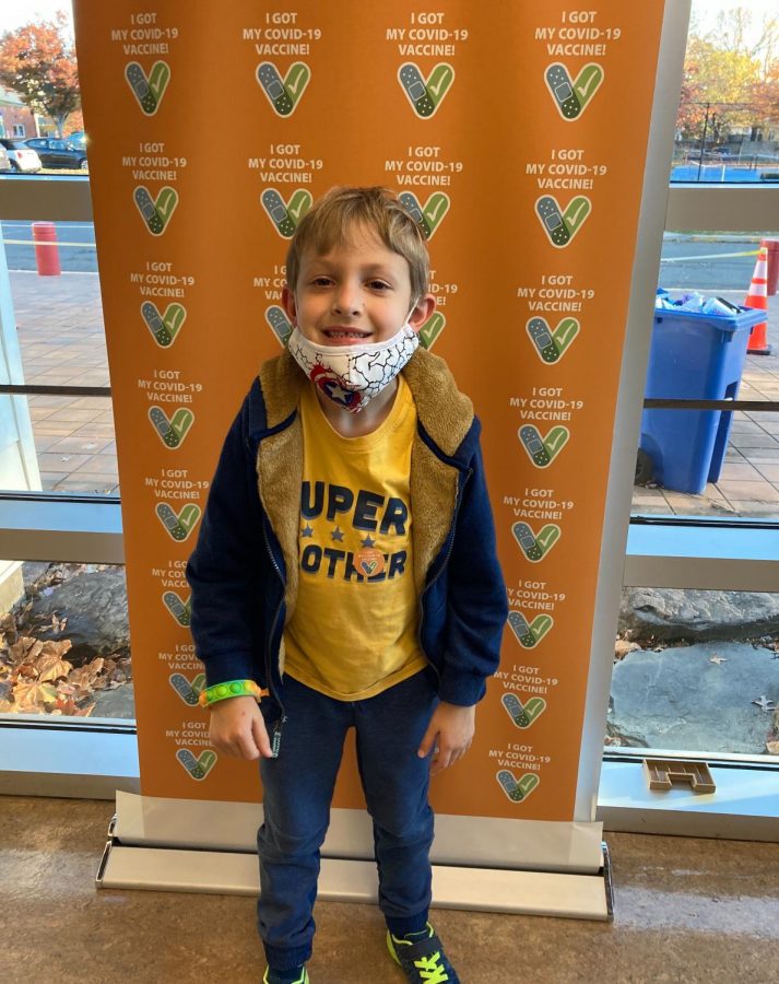 Six-year-old Oliver Elmshaeuser proudly wears his I got my COVID vaccine sticker after receiving his first COVID shot last week in Arlington, Virginia.