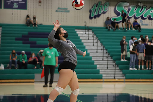 Senior Marina Cadilli (#23) serves the ball at an away game versus Standley Lake 