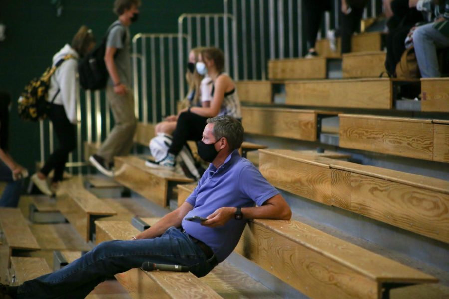 CHS Principal Wesley Paxton watches the Muscle Match volleyball game during Conifers Homecoming Week. “I depend on my work with [school staff] to brainstorm solutions on how we can reduce budgets but hold onto people who our students thrive under,” Paxton said.