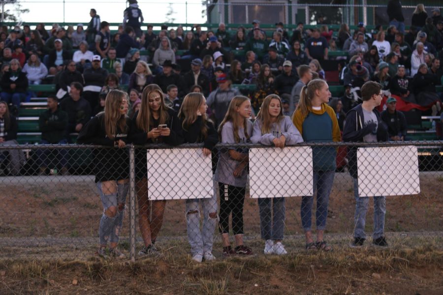 Conifer students watch the 2022 Homecoming football game. “There are a lot of memories that are going to be made in high school, and I would hate for a student to be so stressed out because they’re worried about becoming valedictorian that they ruin their final semester in high school,” school counselor Justin Neuenschwander said.