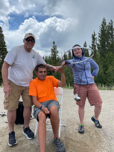 EPRD Staff member Patrick Quinlan helps INSPIRE participants Mac Teaff (center) and Grace Arnold (right) to fish at a program outing.