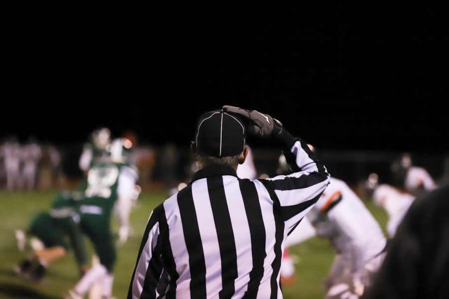A high-school football referee makes a call during the Conifer game against opponents Lewis Palmer last year.
