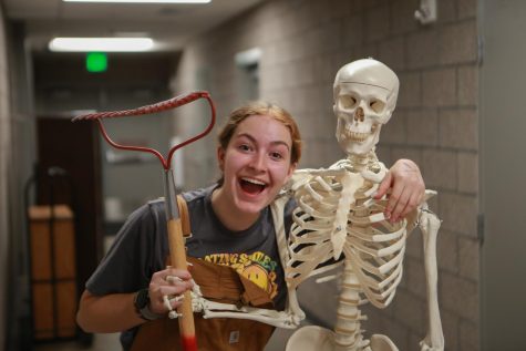Alyson Westfall posing with the HOSA skeleton at Trick or Treat Street. Keep Conifer Green ran a booth at the event on October 26th.