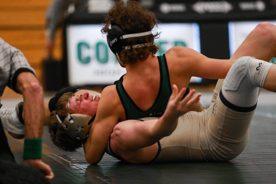 Jacob Reynolds pinning his bloodied Evergreen opponent to the mat. Reynolds emerged victorious from his match. “I was nervous, my last match ever on conifer high school soil, Reynolds said.
