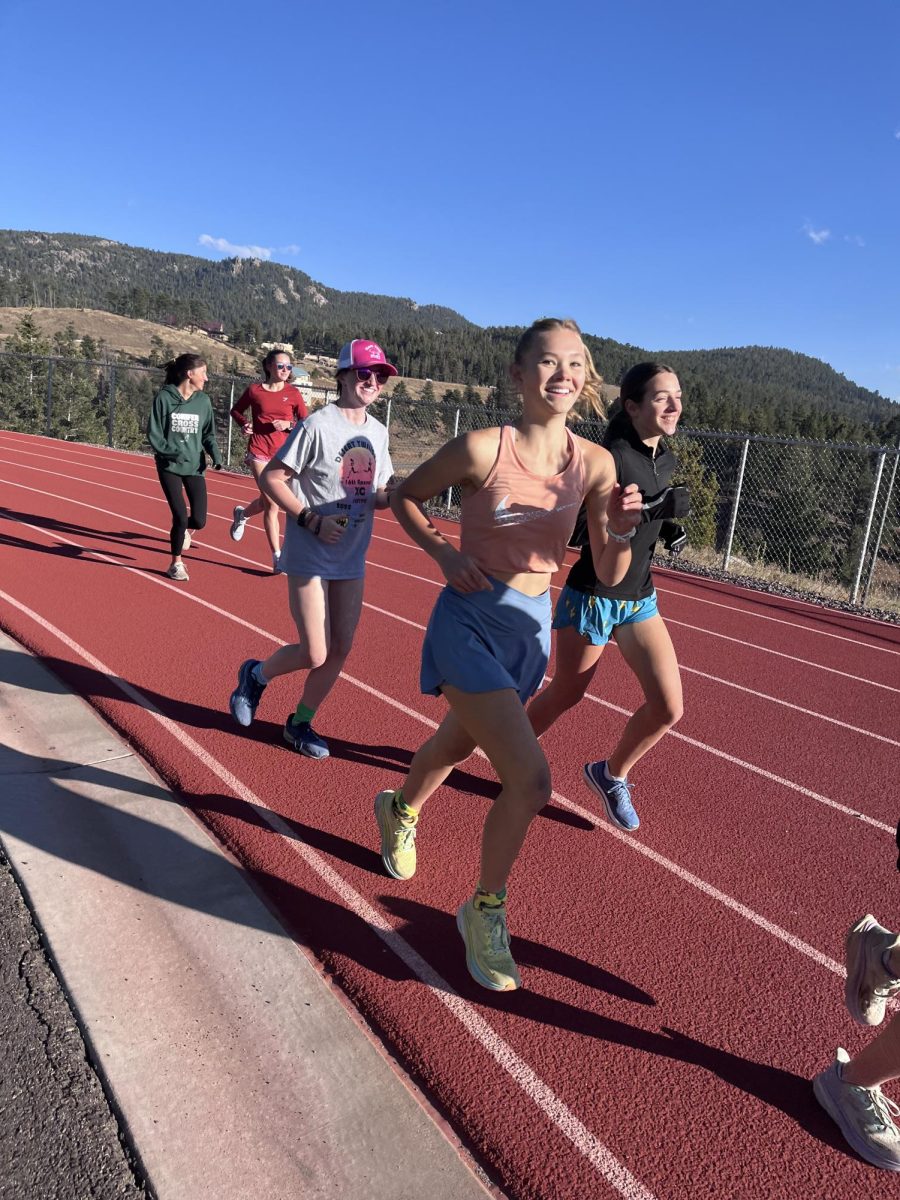 The Varsity cross country girls run laps around the track on October 27, 2023 getting ready for state. “I think you reach a new mental sport, reaching mental and physical barriers, and learning so many new things about yourself, freshman Indyka Fleury said.