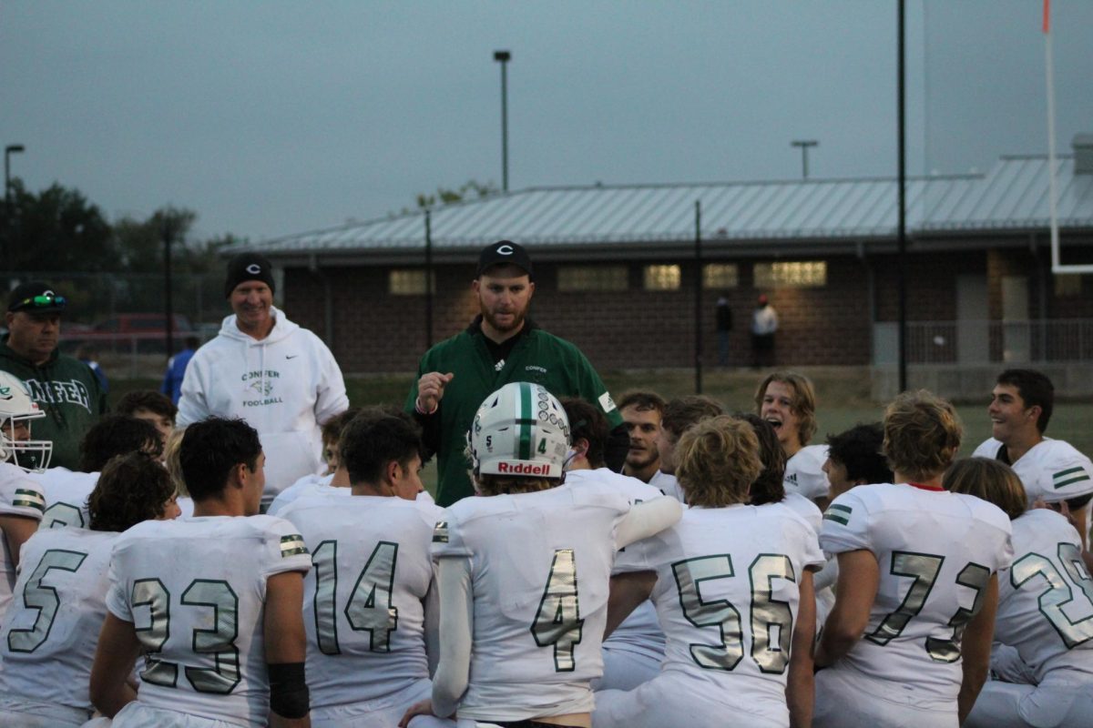 Head football coach Jonathan Shipley gives a halftime pep talk to the Varsity team. They were playing away against Wheat Ridge, their sixth game of the 2022-2023 season. “Just an amazing group of young men and women up here at Conifer High School and I’ve been very fortunate to coach and teach some amazing people and keep those friendships and relationships alive even after they graduate,” Shipley said.