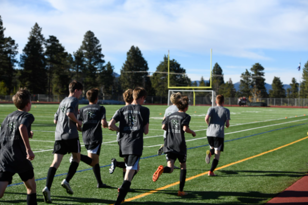 Conifer Lobos Junior Varsity Team warming up before the start of their game. They ran laps around the field about 5 times before going back to individual warmups. “I feel we’ll perform well,” Freshman Aaron Drake stated, “We haven’t been performing that good recently. Hopefully we will step it up for this game.” 
