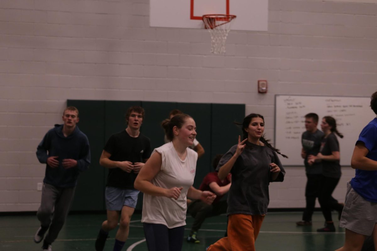 Wrestling team run laps around the mats at the end of their 2 hour practice for some extra conditioning. “I lose 4 pounds of weight every single practice. That’s just how hard we work,” Junior Olivia Adamson said.  
