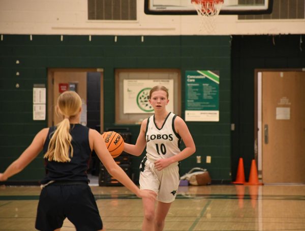 Freshman Maddison Doig takes the ball up the court in a Junior Varsity game against the Littleton Lions on January 22nd hosted at Conifer. The game ended 59-6 moving their League record to 0-2. “ I am feeling very confident, I know our team has worked very hard and we have gotten better since the beginning of the year,” Sophomore Sydney Pierce said.