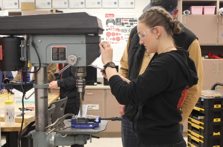 Evelyn Seevers drills new holes into a piece of metal for Team Blitz’s robot. With the goals of being more precise in their measurements and cuts, it is very important as to not drill in the wrong spots or have too wide of a diameter for the hole in order to ensure that the robot will run as smoothly as possible.
