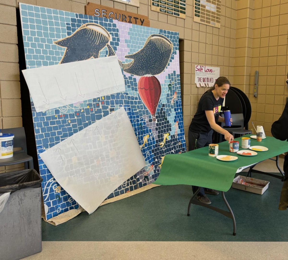 Ms. Svigel working a stand to help the Class of 2024 leave their fingerprints on the finished mural. She offered a variety of colors for the seniors fingerprints as a part of the mural, allowing them to leave a part of them with the school before they step out into the next chapter of their life. “I do not have much say in how it will look other than there needs to be a place where the seniors will place their fingerprints, and that it needs to be to represent the school as a whole body, and not just a few students,” said Svigel. 