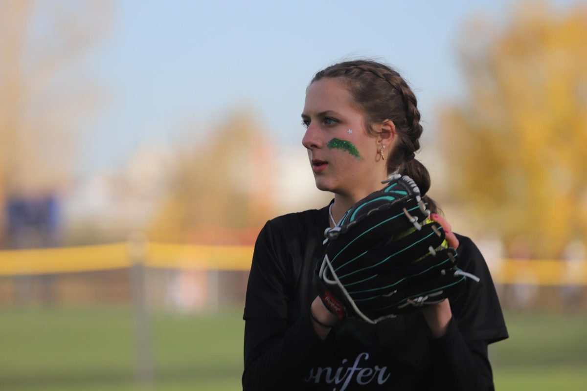 Junior Sophie Kramer prepares a throw during practice before the 2024 softball state championships. Contrasting with last year’s sixteen player team, Conifer’s softball team is starting this year with only nine players, the minimum amount required for a varsity team, leaving seniors with the chance of being unable to play a varsity season at Conifer this year. “I’m really hoping we can get a few more girls and keep playing varsity, especially for senior season,” senior player Giada De Manna said.