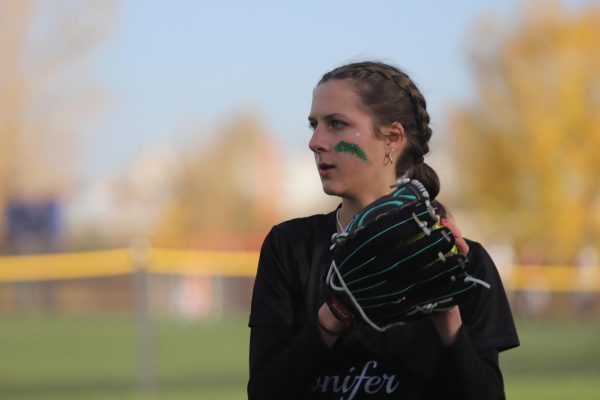 Junior Sophie Kramer prepares a throw during practice before the 2024 softball state championships. Contrasting with last year’s sixteen player team, Conifer’s softball team is starting this year with only nine players, the minimum amount required for a varsity team, leaving seniors with the chance of being unable to play a varsity season at Conifer this year. “I’m really hoping we can get a few more girls and keep playing varsity, especially for senior season,” senior player Giada De Manna said.