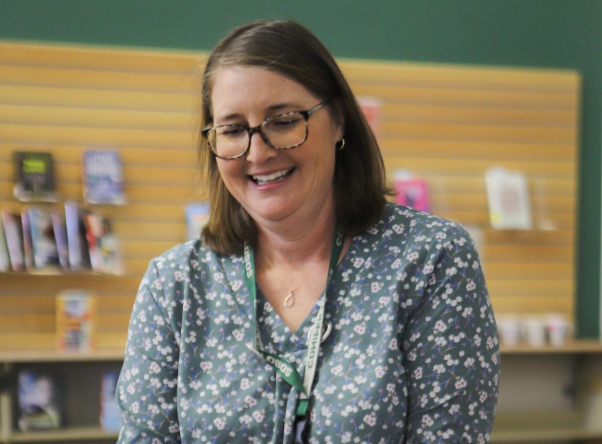 Digital Teacher Librarian Karen McIntosh cuts the ribbon to the new CHS library on October 3. The library originally planned to open mid-September, but due to needed setup time and interfering events, the library was instead 'soft-launched,' opening the space for students prior to the official opening and tour. "I love having autonomy and choice over what we want to do with our library space," McIntosh said.