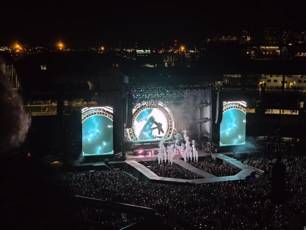 Def Leppard performs on stage as fog and flashing lights fill the air during a high-energy concert at Coors Field in Denver, CO. The band played 
fan-favorite hits and high-energy songs, drawing longtime fans and new listeners together for a night of rock.